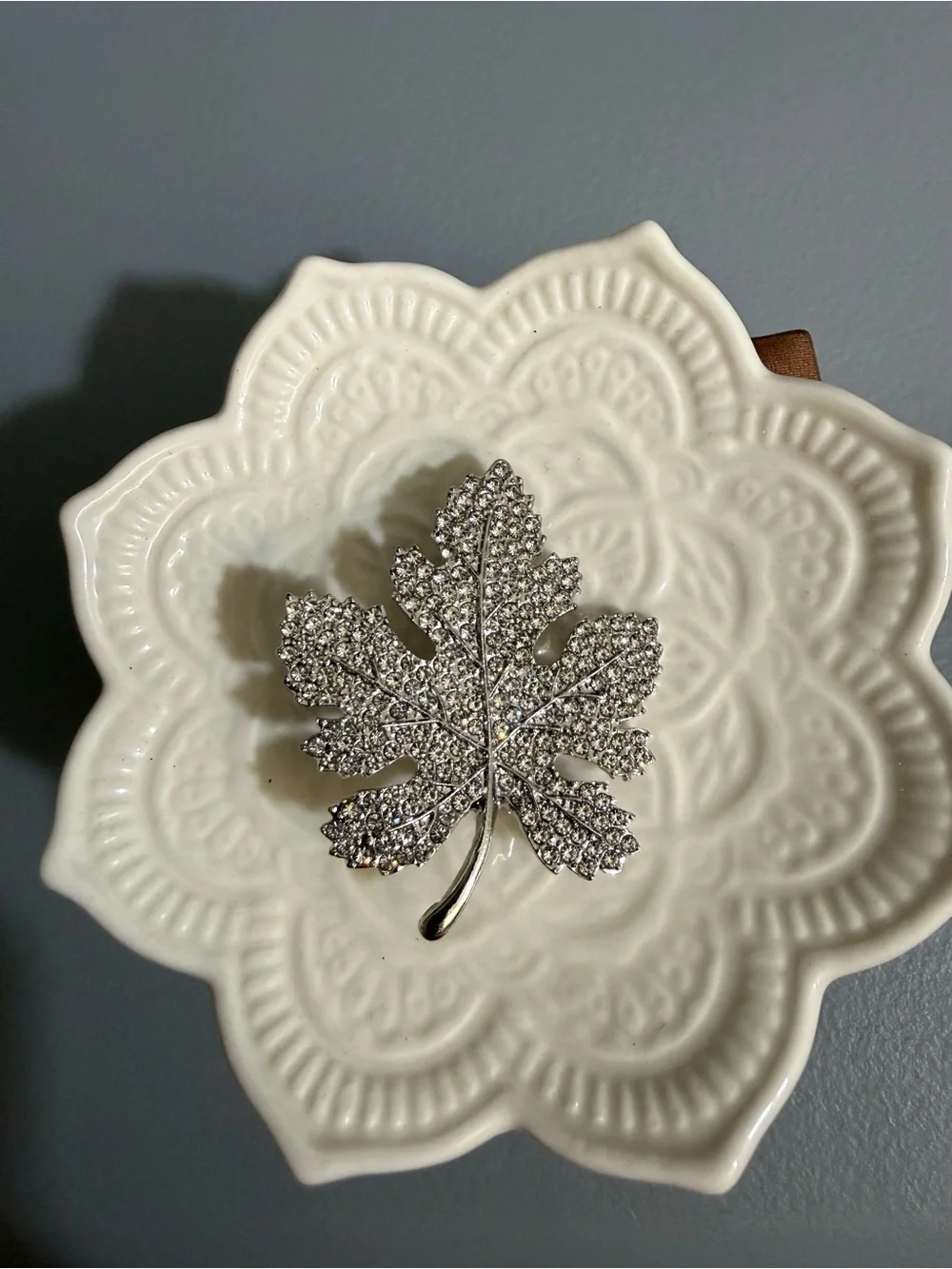 Sparkling silver-tone maple leaf brooches featuring pavé-set clear rhinestones.